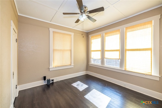 empty room featuring ceiling fan, dark hardwood / wood-style flooring, and ornamental molding