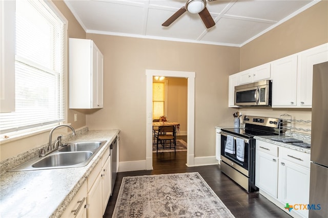 kitchen with appliances with stainless steel finishes, dark hardwood / wood-style flooring, coffered ceiling, sink, and white cabinets