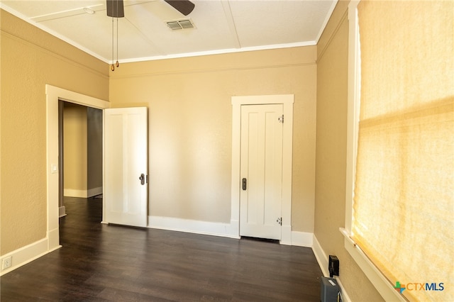 interior space with ceiling fan, crown molding, and dark wood-type flooring