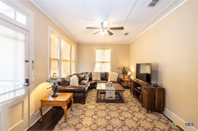 living room featuring ceiling fan, plenty of natural light, and ornamental molding