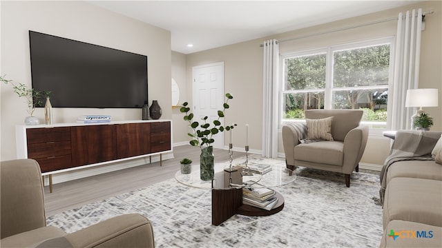 living area featuring recessed lighting, light wood finished floors, and baseboards