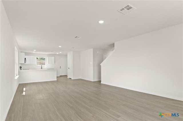 3815 Leming Ct, Temple, TX 76504 - unfurnished living room with recessed lighting and light wood-type flooring