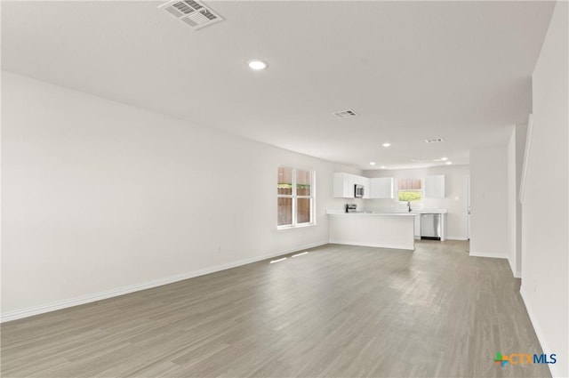 3815 Leming Ct, Temple, TX 76504 - unfurnished living room with light wood finished floors and recessed lighting