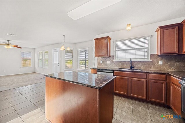 4805 Farrell Ln, Killeen, TX 76549 - kitchen with a center island, ceiling fan, open floor plan, decorative backsplash, and dark stone countertops