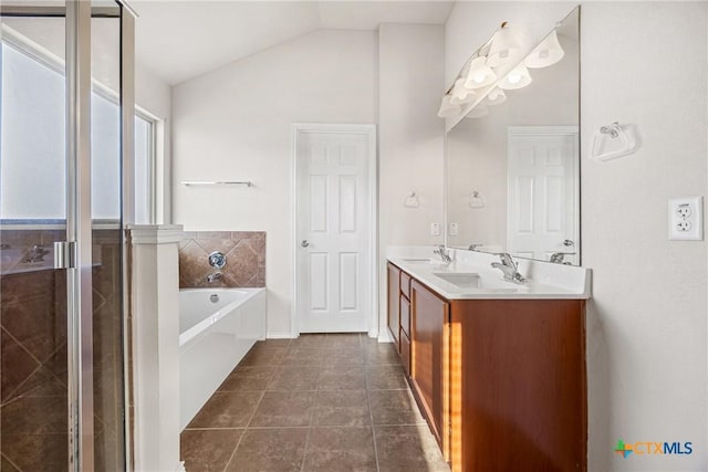 4805 Farrell Ln, Killeen, TX 76549 - full bath featuring a bath, double vanity, vaulted ceiling, a stall shower, and tile patterned flooring