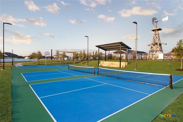 view of tennis court with a lawn