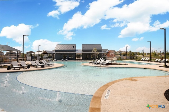 view of pool with pool water feature and a patio area