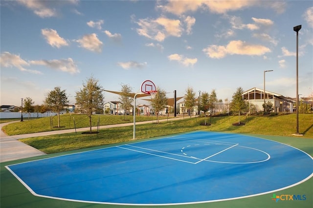 view of sport court featuring a lawn