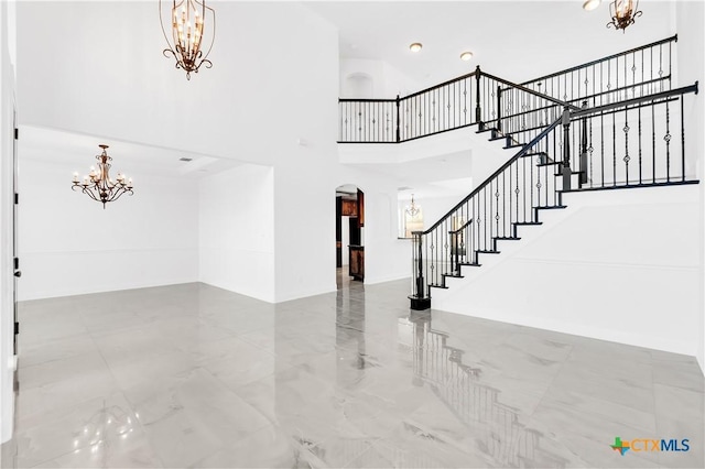 foyer entrance featuring a high ceiling and a chandelier