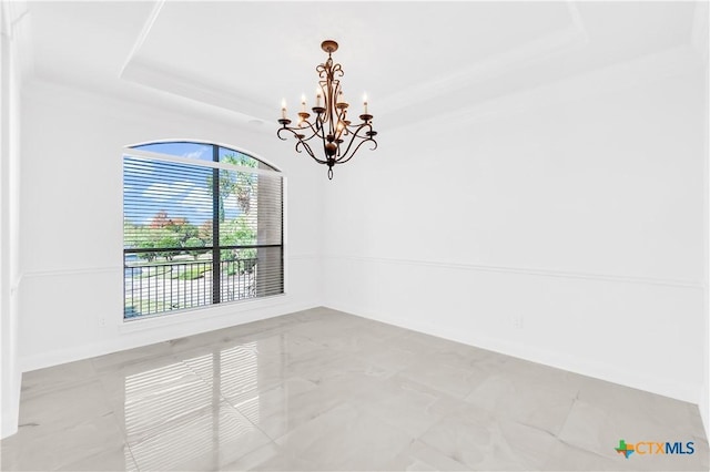 unfurnished room with a raised ceiling and a notable chandelier