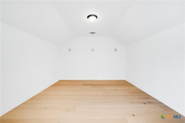 bonus room featuring lofted ceiling and hardwood / wood-style flooring