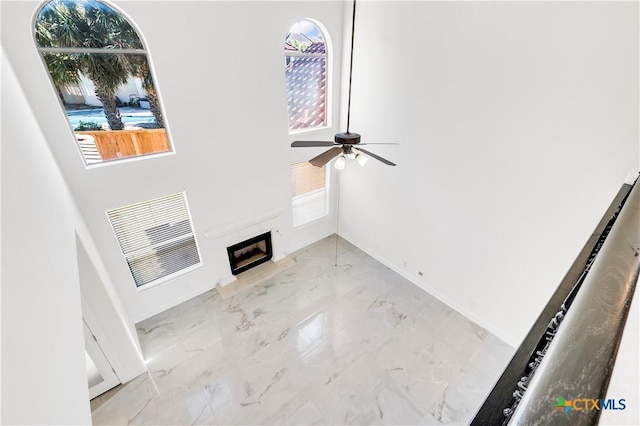 unfurnished living room featuring ceiling fan