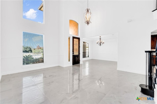 living room featuring a high ceiling and a notable chandelier