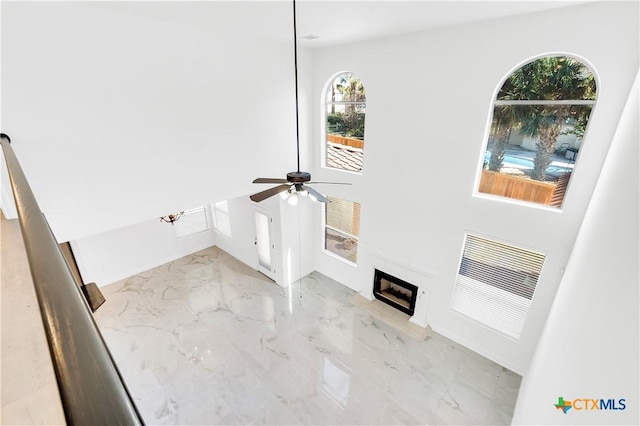 unfurnished living room featuring ceiling fan