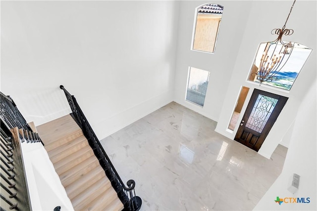 entryway with a wealth of natural light and a notable chandelier