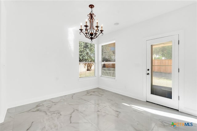 unfurnished dining area with a chandelier and a healthy amount of sunlight