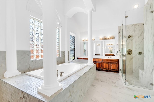 bathroom with shower with separate bathtub, ornate columns, and vanity