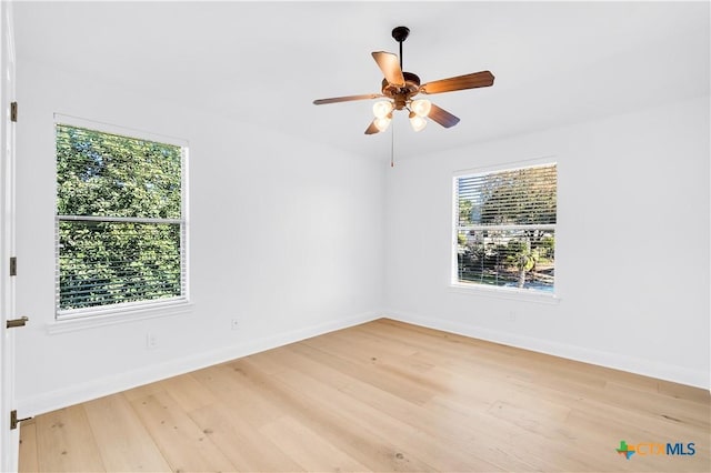 empty room featuring light wood-type flooring and ceiling fan