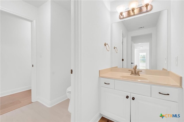 bathroom with toilet and vanity