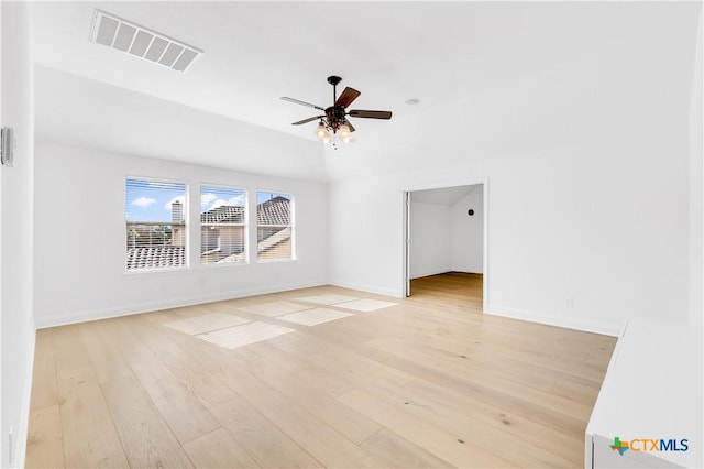 unfurnished living room featuring lofted ceiling, ceiling fan, and light wood-type flooring