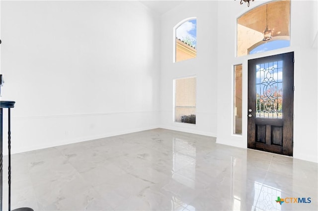 entryway featuring a high ceiling and a notable chandelier