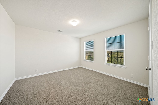 unfurnished room featuring carpet