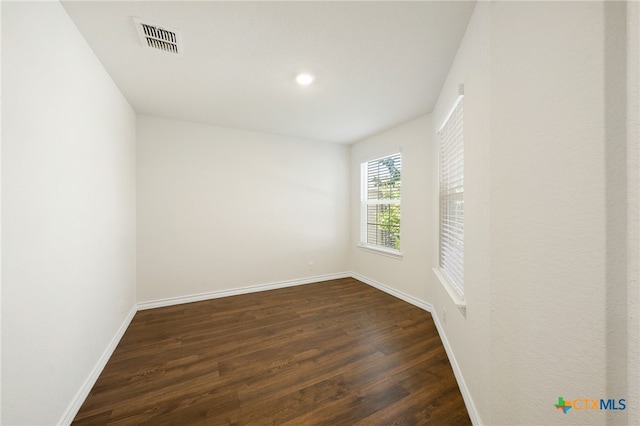 unfurnished room featuring dark hardwood / wood-style flooring