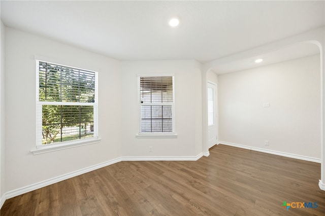 unfurnished room featuring dark hardwood / wood-style flooring