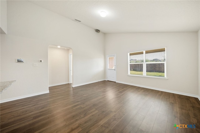 unfurnished room with vaulted ceiling and dark hardwood / wood-style floors