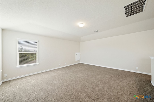 carpeted empty room featuring lofted ceiling