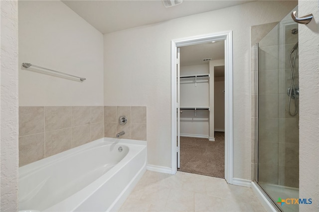 bathroom with shower with separate bathtub and tile patterned floors