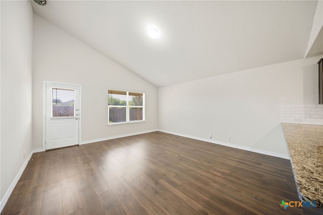 unfurnished living room with dark hardwood / wood-style flooring and high vaulted ceiling