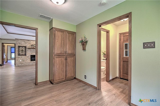 2702 Olympia Dr, Temple, TX 76502 - hallway with light wood finished floors and a textured ceiling