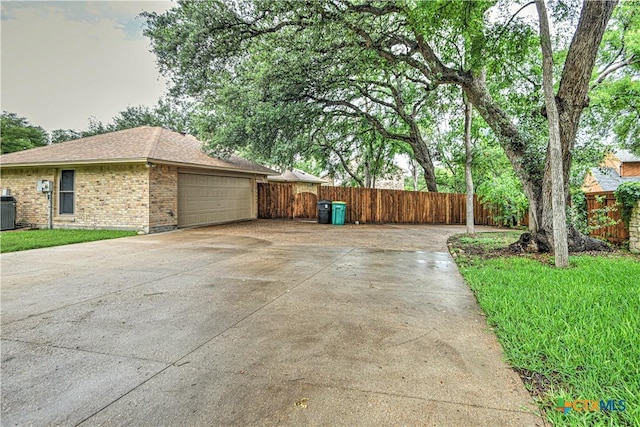 2702 Olympia Dr, Temple, TX 76502 - view of home's exterior featuring concrete driveway, a garage, brick siding, and a shingled roof
