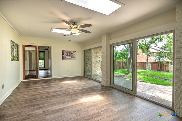 2702 Olympia Dr, Temple, TX 76502 - unfurnished room with a skylight, a ceiling fan, wood finished floors, and ornamental molding