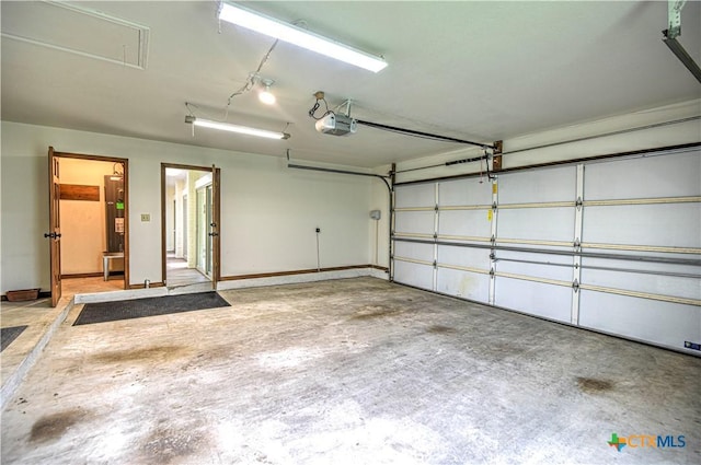 2702 Olympia Dr, Temple, TX 76502 - garage with a garage door opener and baseboards