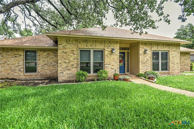 2702 Olympia Dr, Temple, TX 76502 - single story home featuring a front lawn, brick siding, and a shingled roof