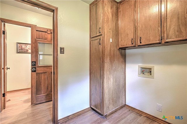 2702 Olympia Dr, Temple, TX 76502 - laundry room with cabinet space, hookup for a washing machine, and light wood-style floors