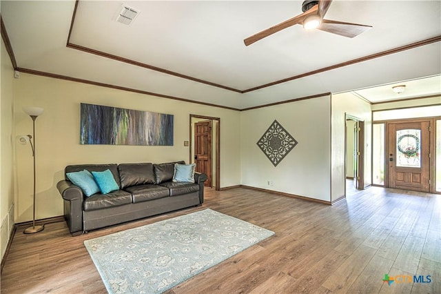 2702 Olympia Dr, Temple, TX 76502 - living room with a ceiling fan, wood finished floors, ornamental molding, and a tray ceiling