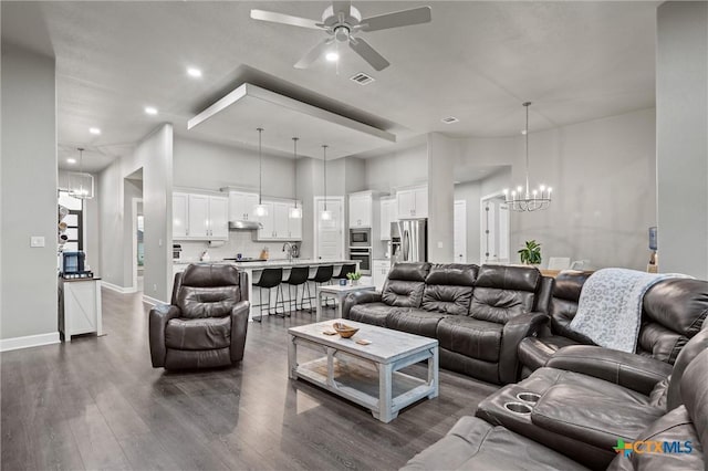 2716 Prairie Chapel Ct, Temple, TX 76502 - living area featuring a chandelier, ceiling fan, recessed lighting, dark wood-style floors, and baseboards