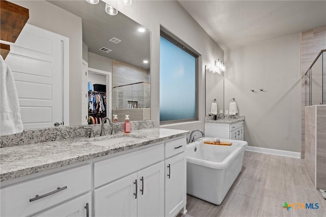 2716 Prairie Chapel Ct, Temple, TX 76502 - bathroom with a shower stall, vanity, a freestanding bath, and a spacious closet