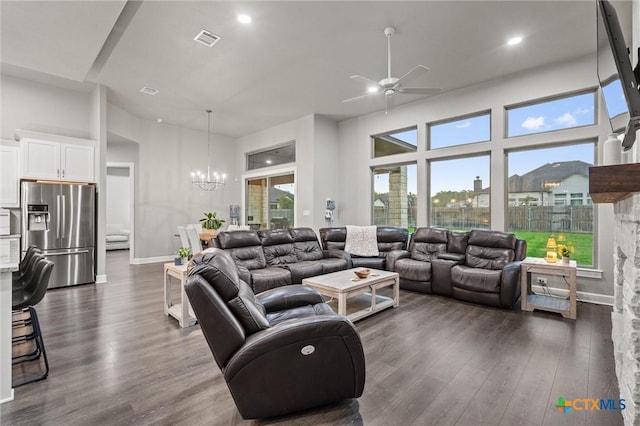2716 Prairie Chapel Ct, Temple, TX 76502 - living room with a chandelier, a ceiling fan, dark wood-style flooring, plenty of natural light, and a towering ceiling