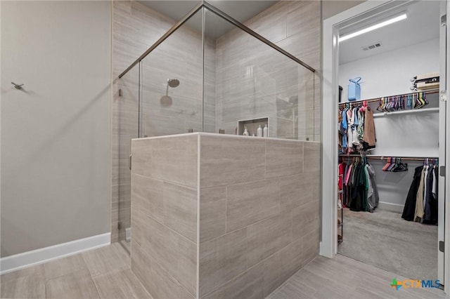2716 Prairie Chapel Ct, Temple, TX 76502 - bathroom featuring a stall shower, a spacious closet, and baseboards