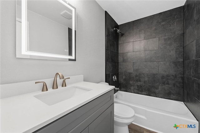 bathroom featuring shower / bathtub combination, visible vents, vanity, and toilet