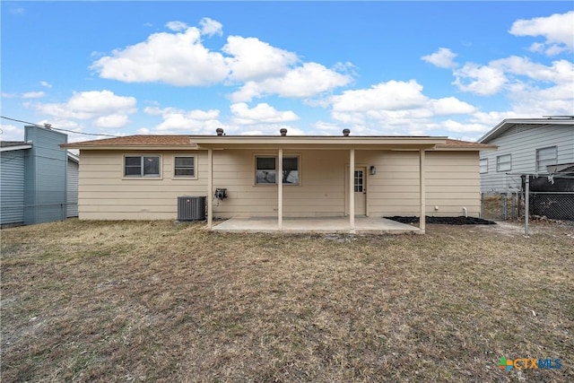 back of house featuring central air condition unit, a patio area, fence, and a yard