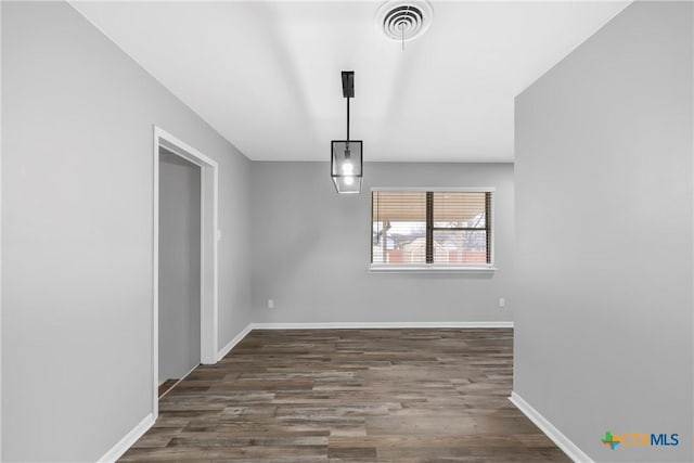 unfurnished dining area featuring dark hardwood / wood-style flooring