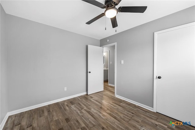 unfurnished bedroom with a ceiling fan, baseboards, and wood finished floors