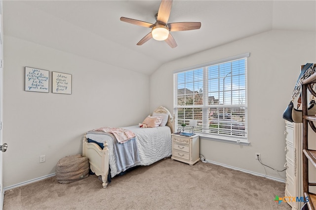 carpeted bedroom with ceiling fan and vaulted ceiling