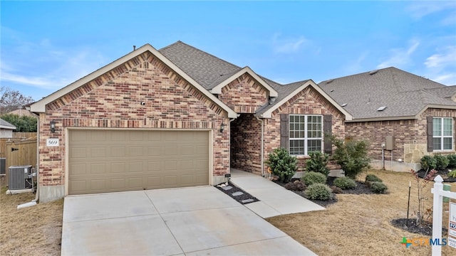 view of front of home featuring central AC unit and a garage