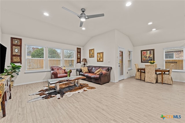 living room featuring ceiling fan, lofted ceiling, and light wood-type flooring